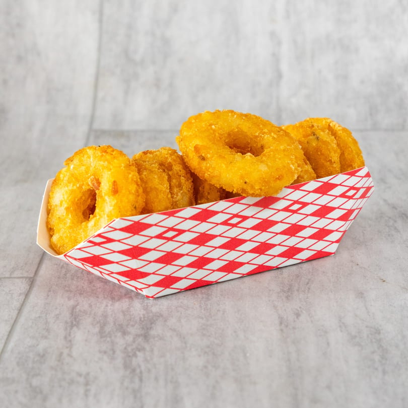 Golden-brown fried calamari rings, a seafood appetizer, served in a red and white checkered paper tray.